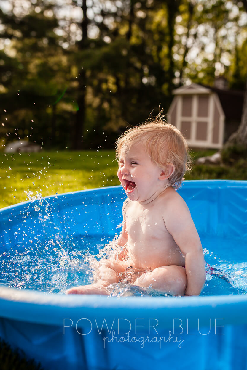 Toddler splashing in baby pool pittsburgh baby photographer