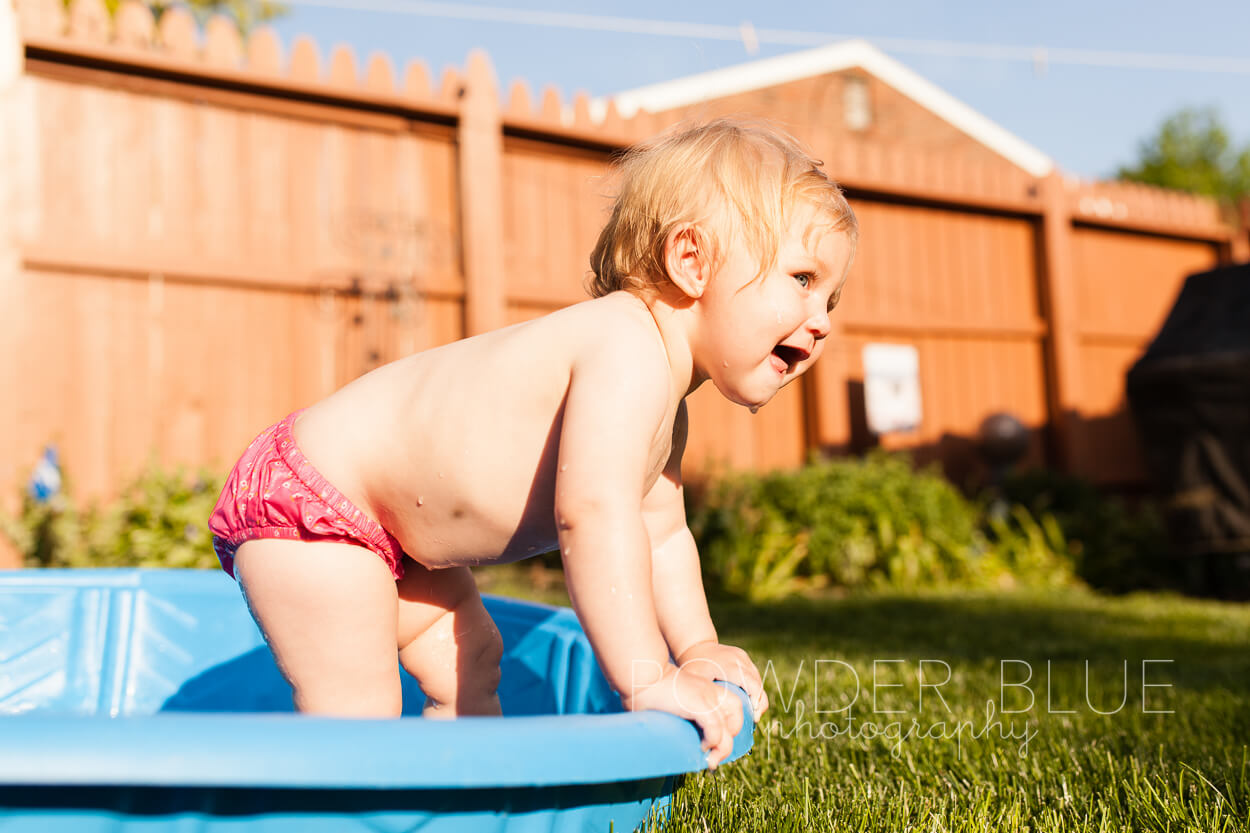 Toddler splashing in baby pool pittsburgh baby photographer