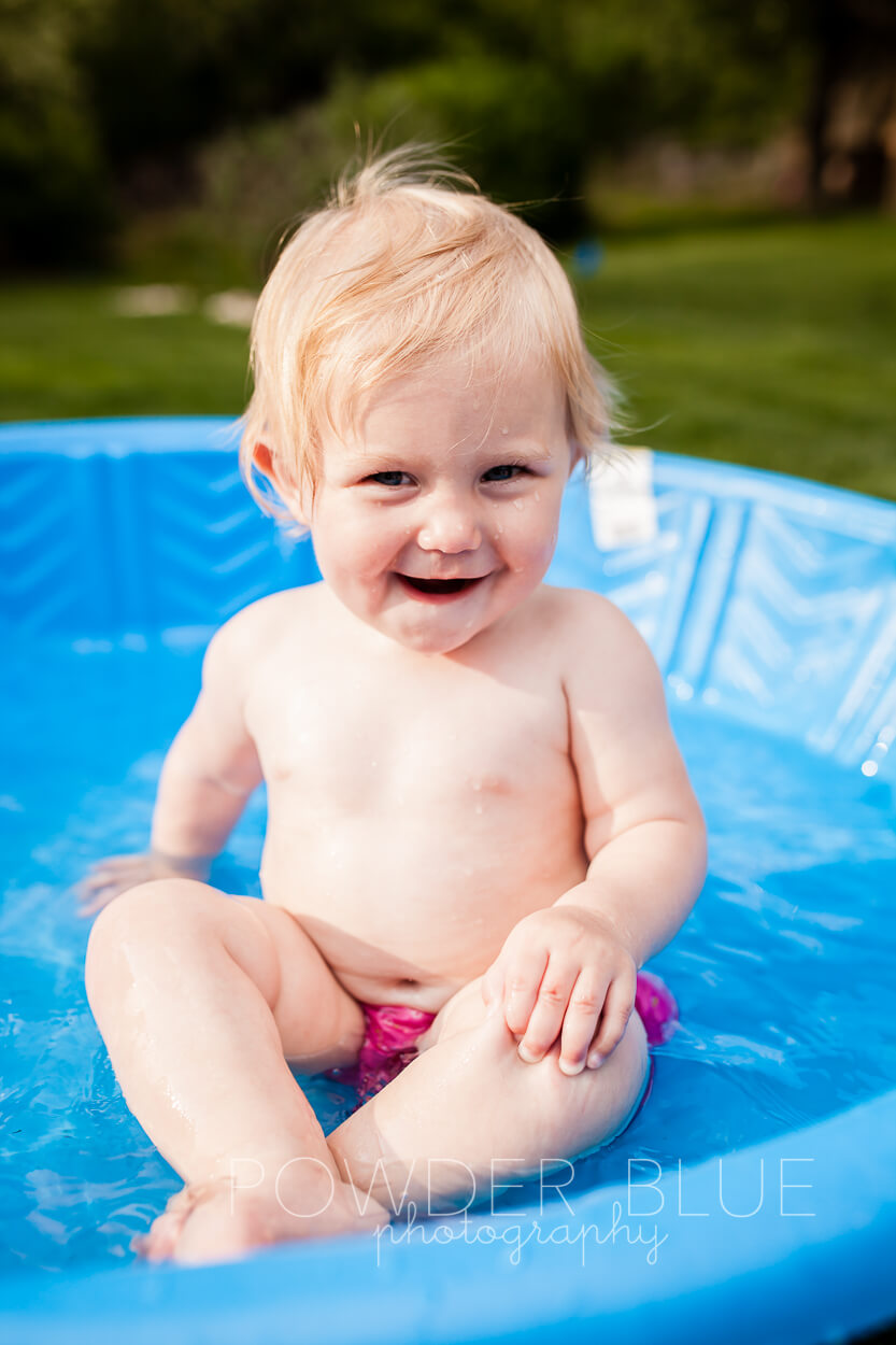Toddler splashing in baby pool pittsburgh baby photographer