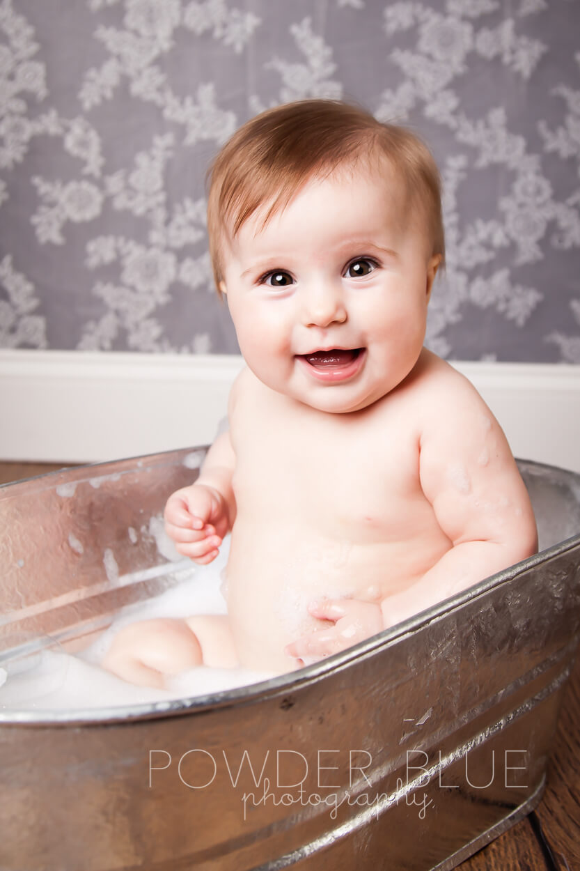 7 month old baby in a bathtub portrait studio