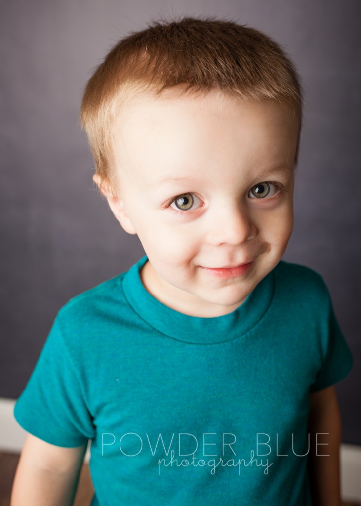 two year old boy in a portrait studio with chalkboard backdrop