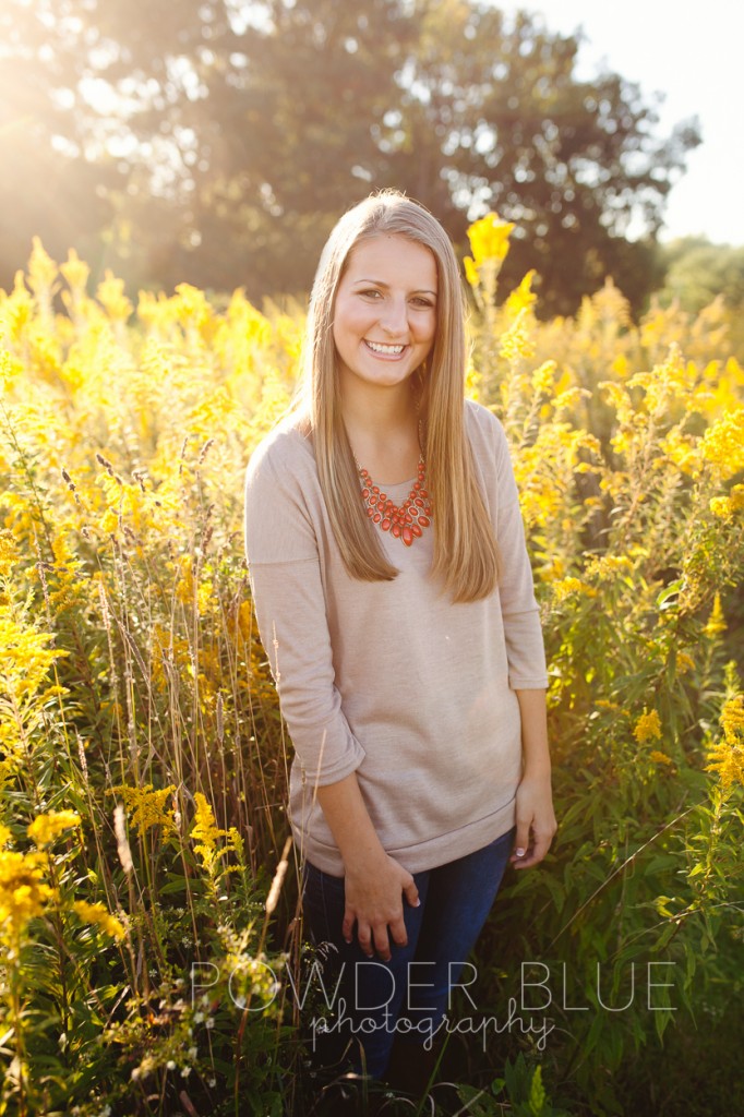 senior girl standing in a field pittsburgh backlit 