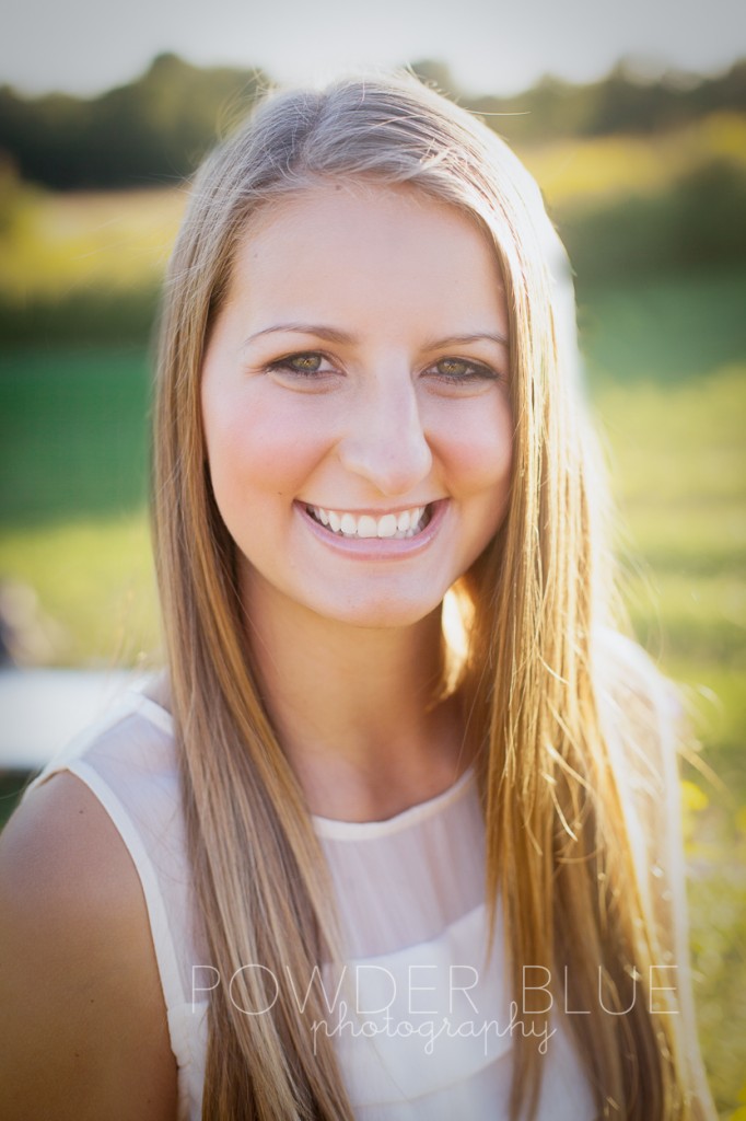 senior girl standing in a field pittsburgh backlit 