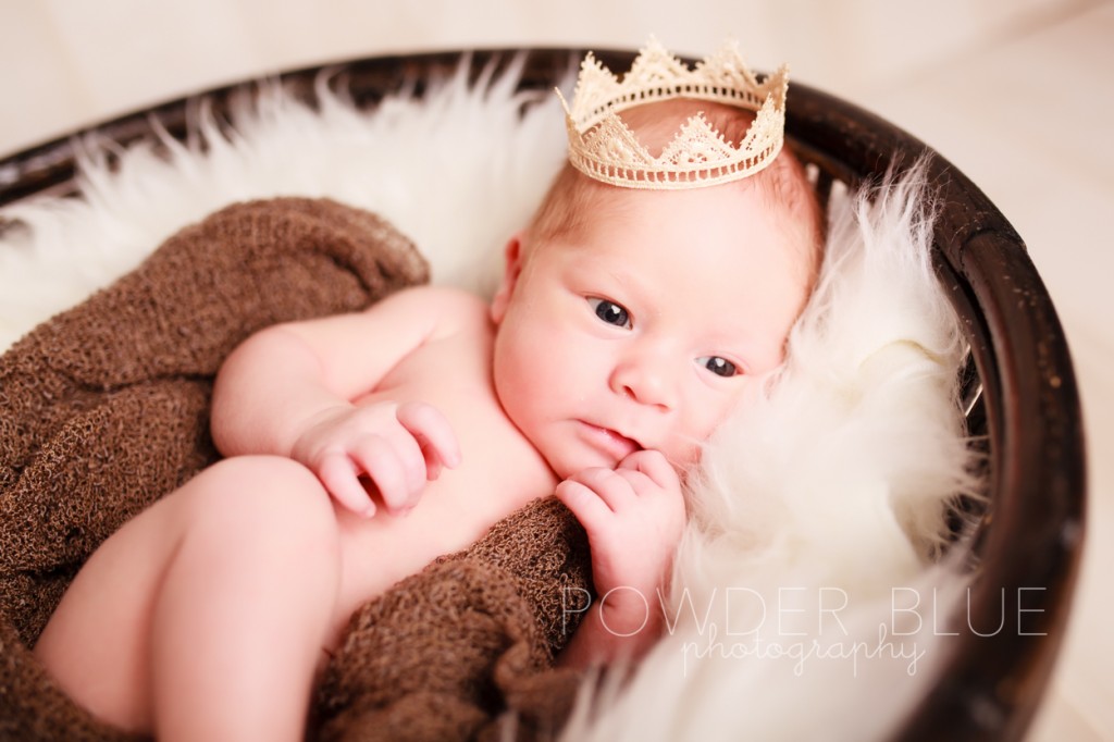 newborn baby wearing a crown