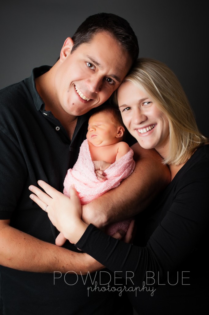 mom and dad with newborn baby studio portrait © 2013 Powder Blue Photography. www.powderbluephoto.com