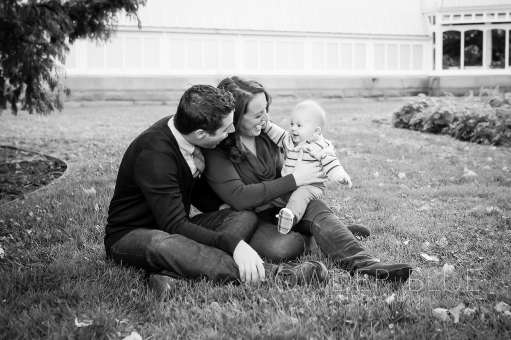 family sitting on grass in front of phipps conservatory pittsburgh schenley park photographer portrait fall leaves pittsburgh portuguese water dog