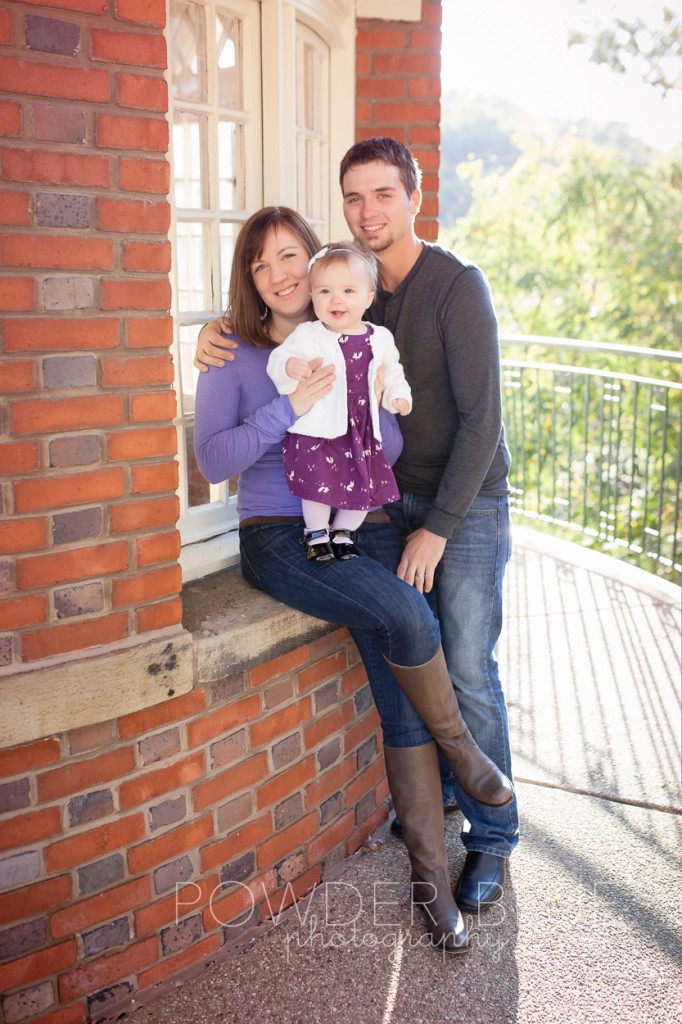 family sitting on a brick wall at schenley park visitor center grey frye melissa boots