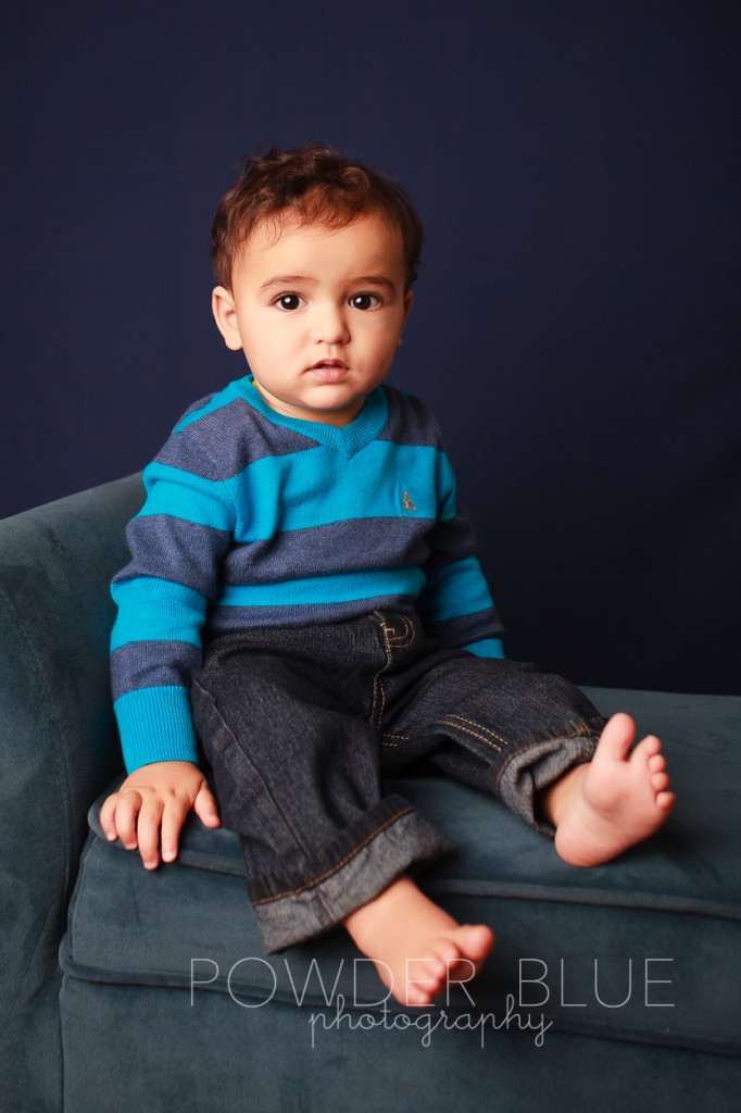 one year old boy studio portrait on navy blue backdrop