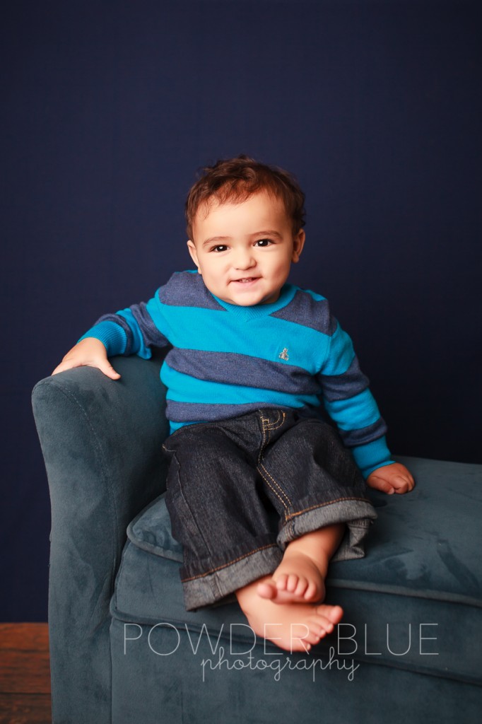 one year old boy studio portrait on navy blue backdrop