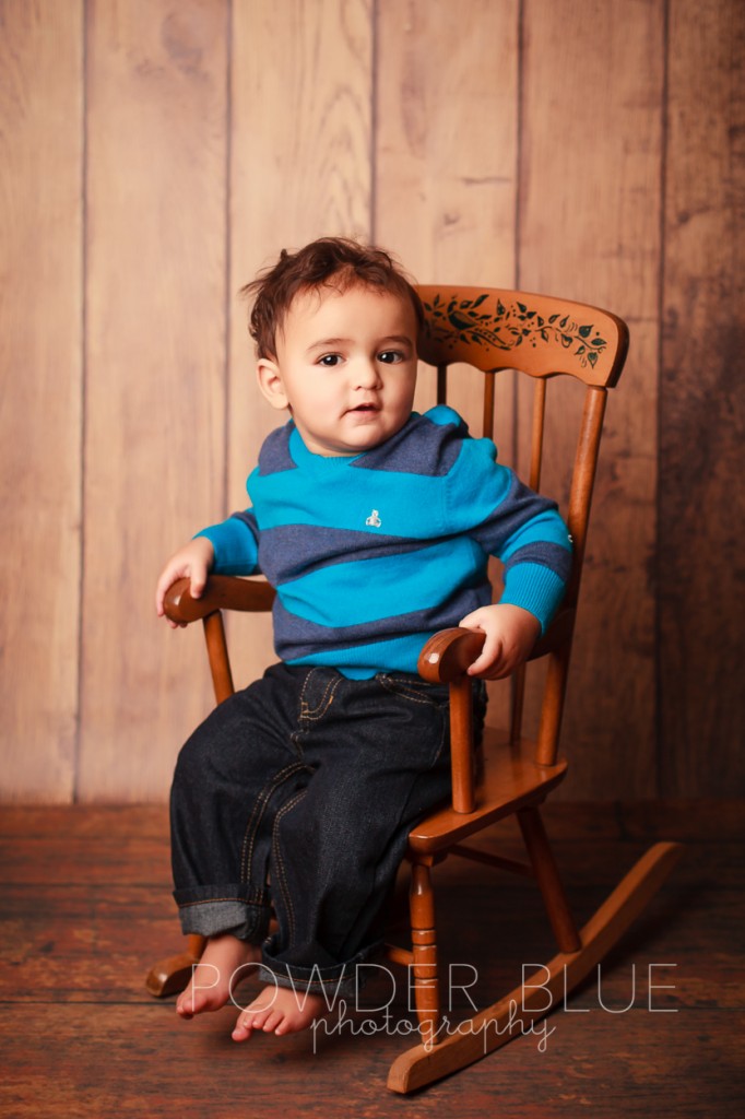 one year old boy studio portrait on navy blue backdrop