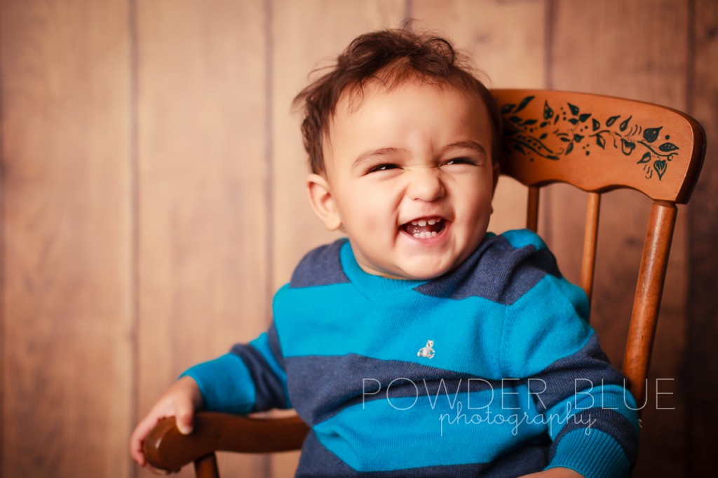 one year old boy studio portrait on navy blue backdrop