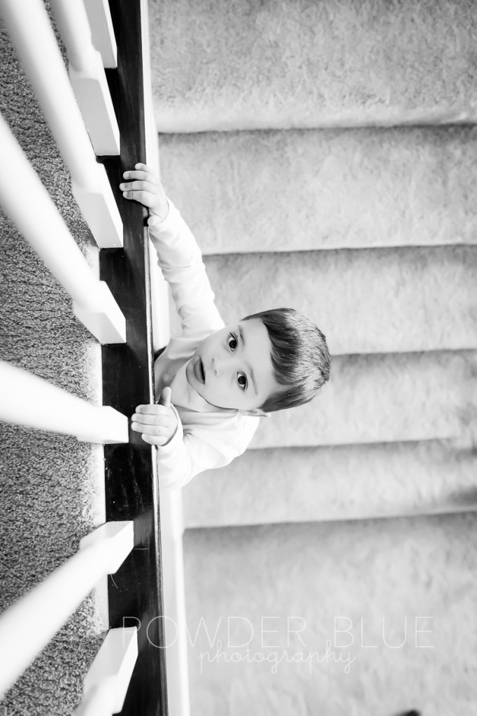two year old toddler boy on staircase black & white photograph