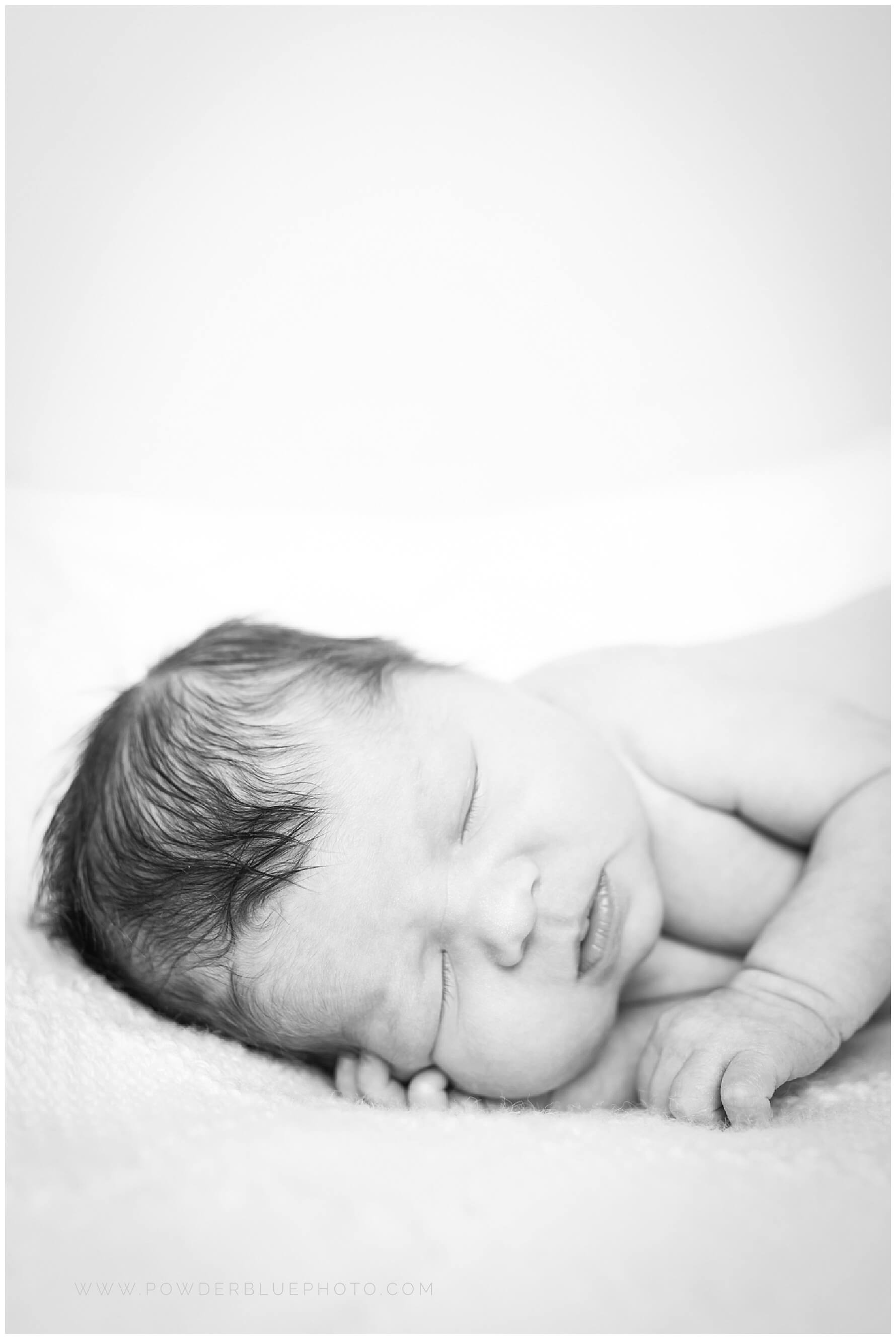 pittsburgh newborn photographer. simple, natural newborn portrait in studio on a white backdrop. baby girl. no props.