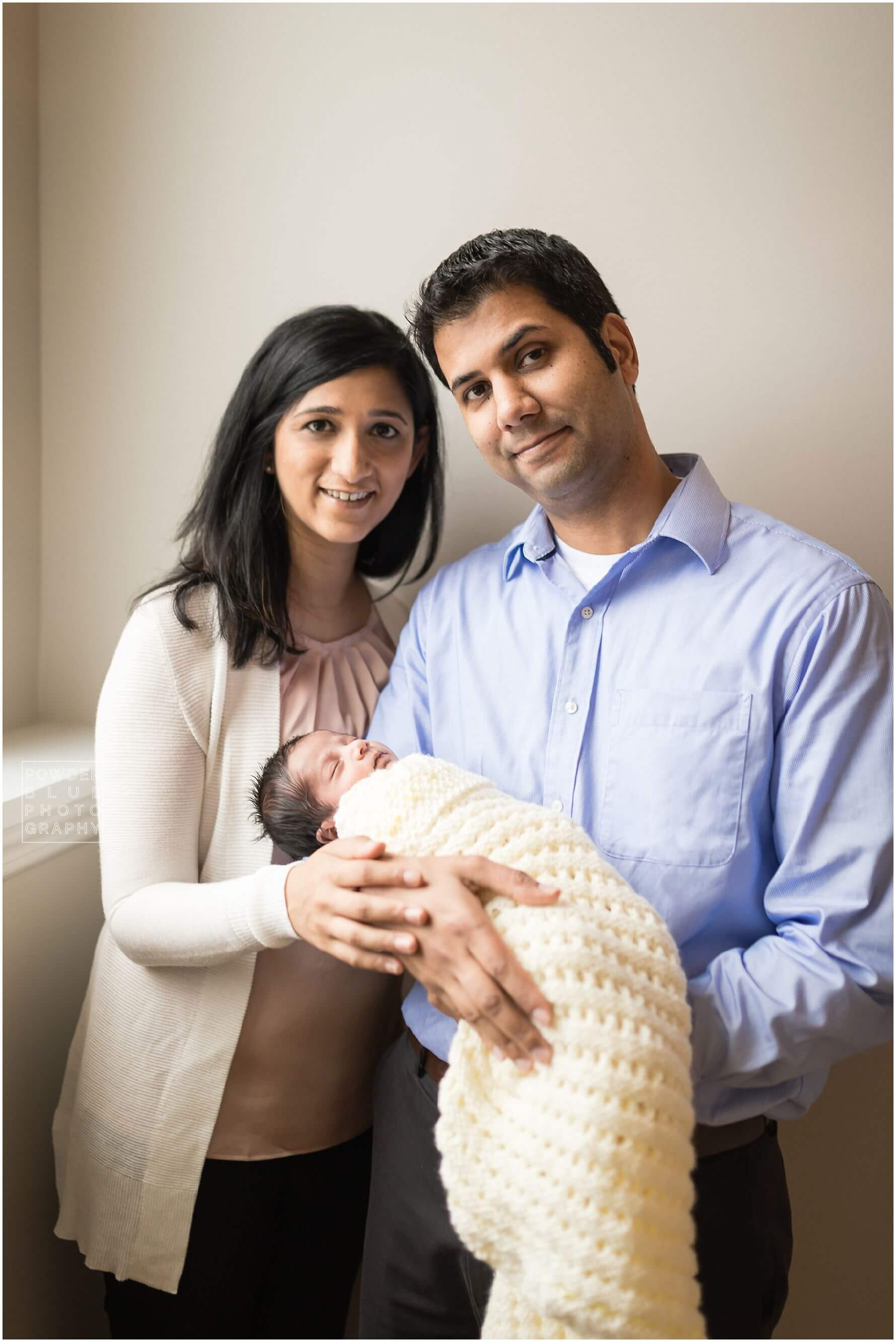 pittsburgh newborn photographer lifestyle photography session. newborn baby in black & white and color portraits on a bed in a home.