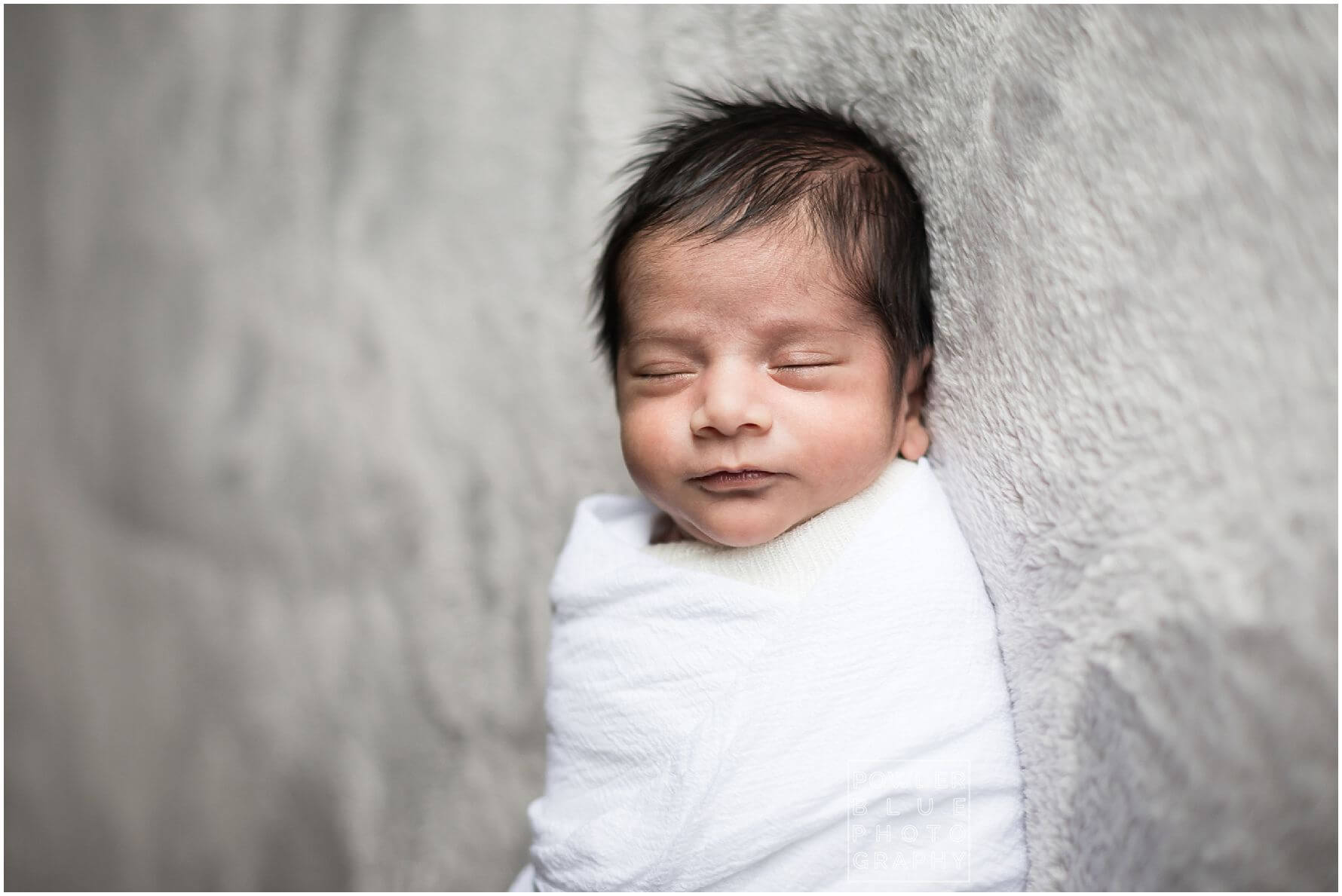 pittsburgh newborn photographer lifestyle photography session. newborn baby in black & white and color portraits on a bed in a home.