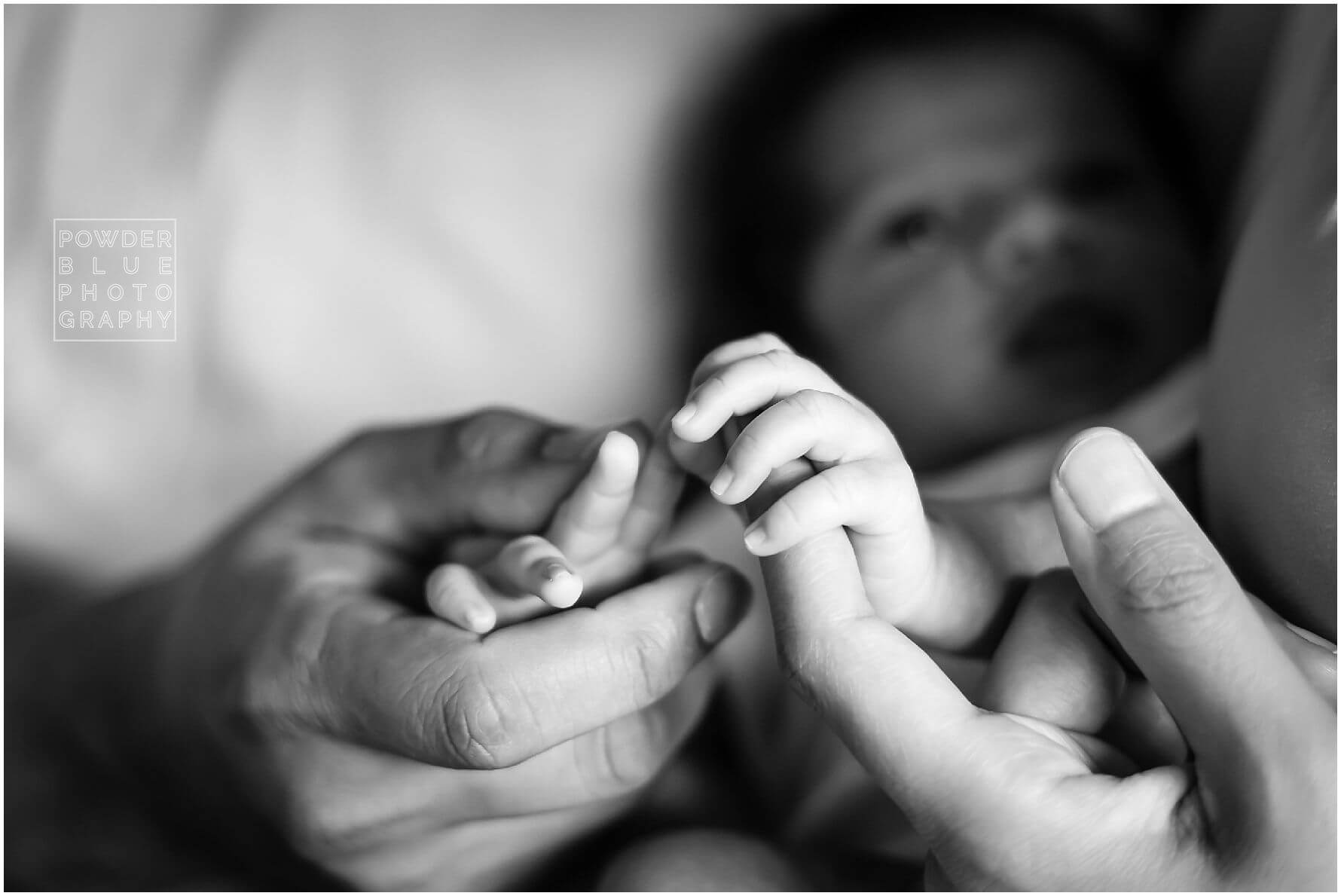 pittsburgh newborn photographer lifestyle photography session. newborn baby in black & white and color portraits on a bed in a home.